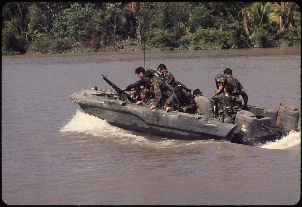 Republic of Vietnam...Members of U.S. Navy Seal Team One move down the Bassac River in a Seal team Assault Boat (STAB) during operations along the river south of Saigon.